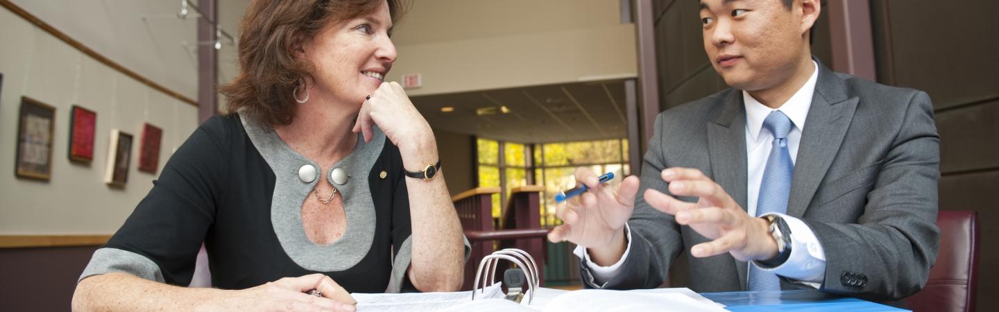 student and professor having conversation