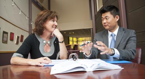 student and professor having conversation