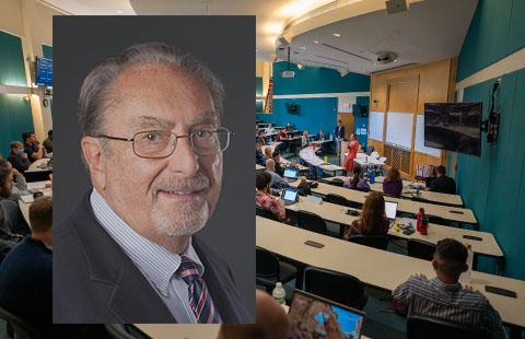 Portrait of Professor Gordon Smith over picture of a classroom