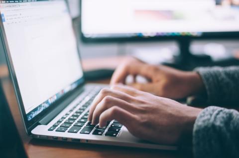 Person typing at a laptop computer