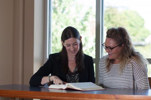 Student and professor in conference room