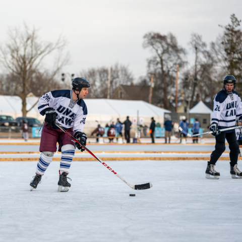 Students playing pond hockey